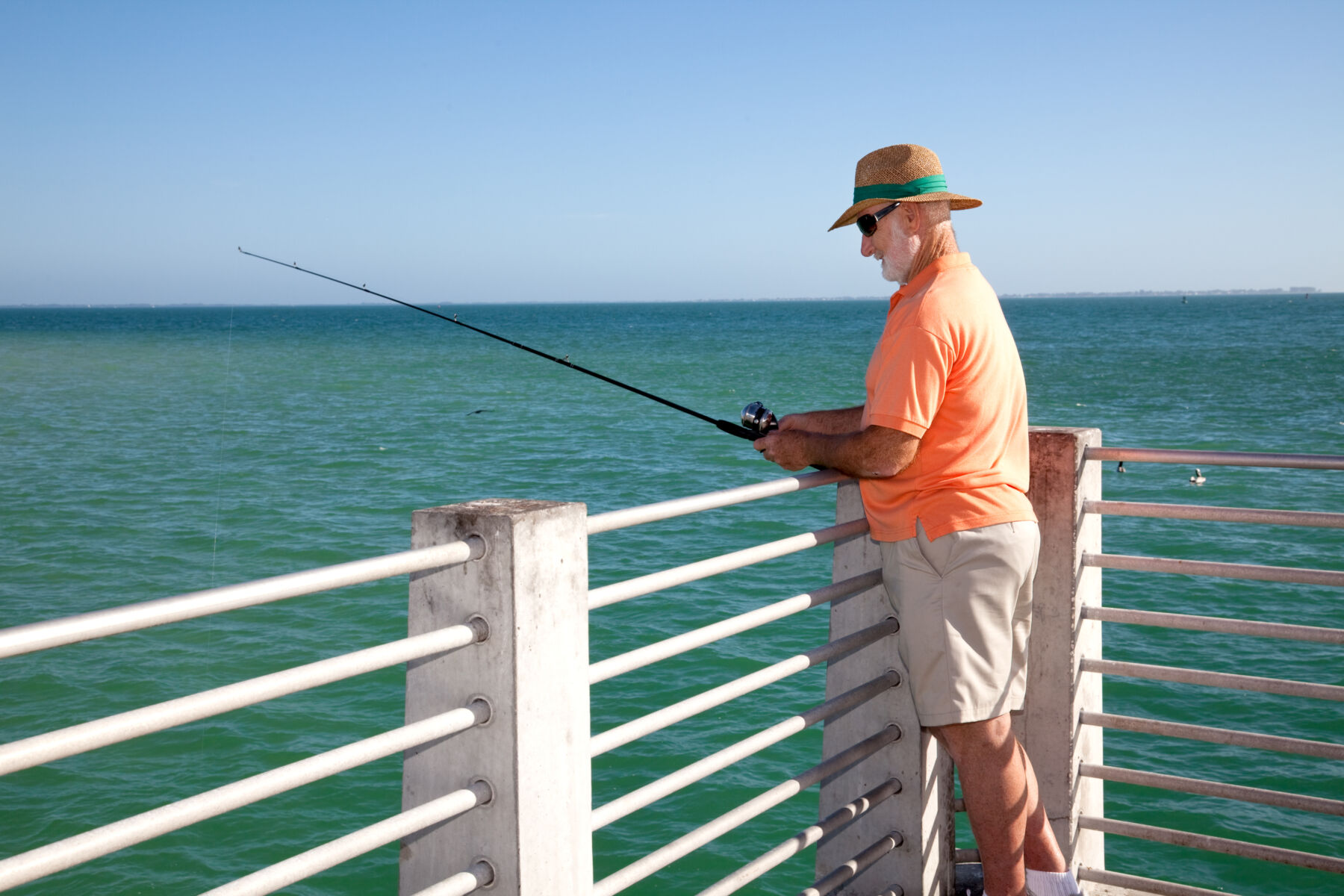 fan fishing off a pier