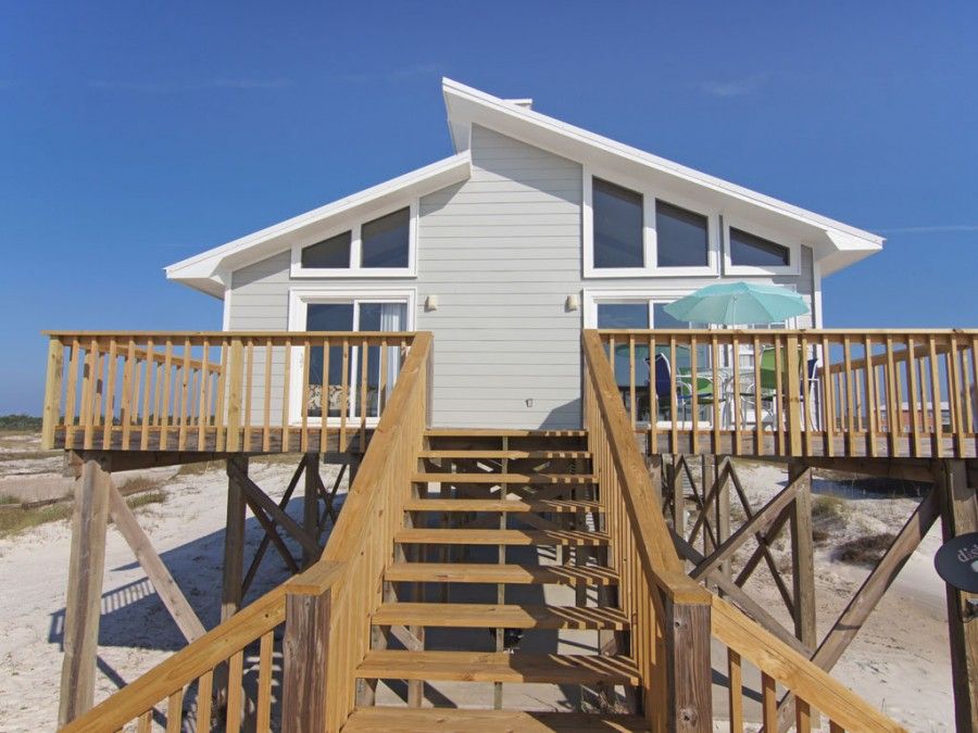 Exterior of gulf shore beach house with full wrap around porch 