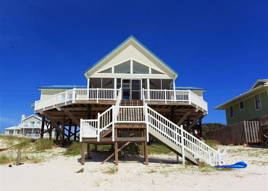 Exterior of yellow ocean front gulf shore beach house.