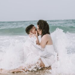 couple kissing in the ocean