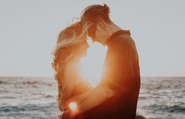 couple on beach at sunset.
