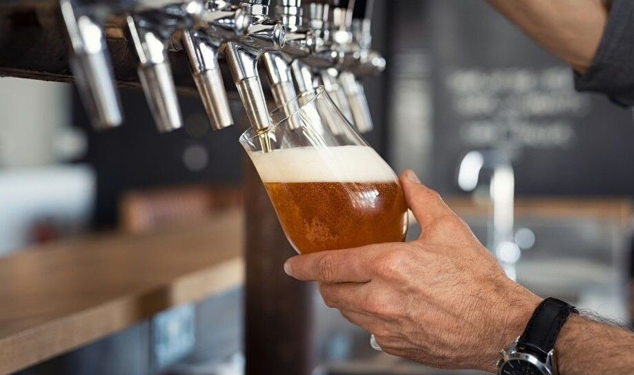 beer being poured from a tap