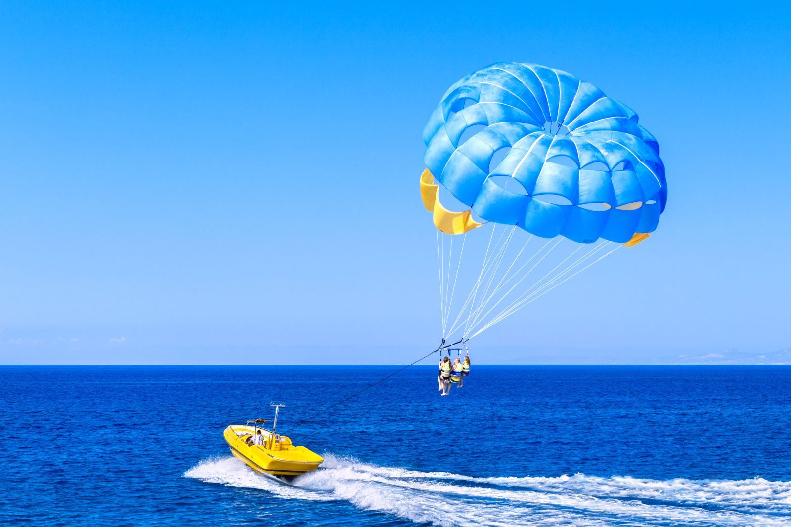 people parasailing by fort morgan