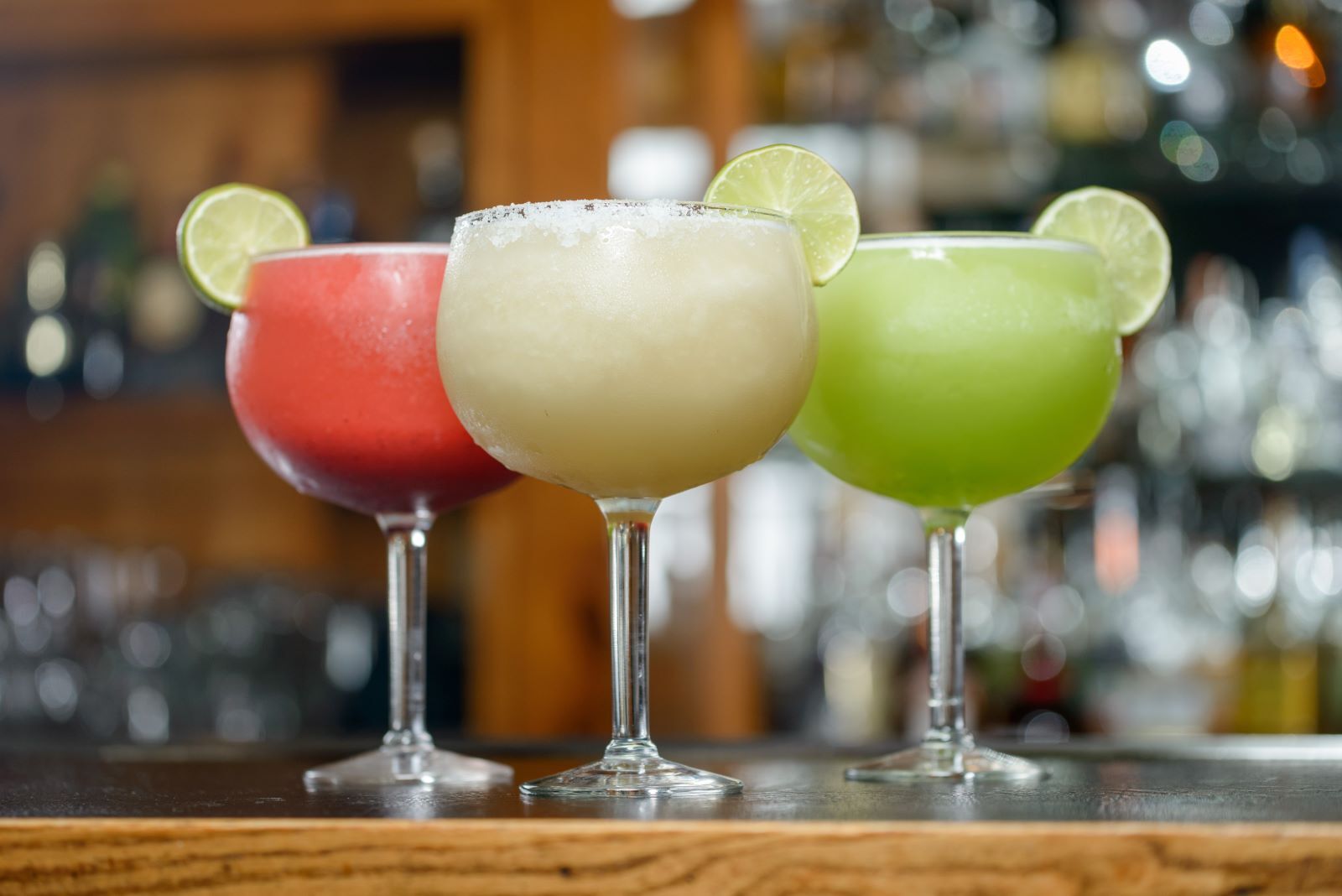 margaritas of three different colors and flavors