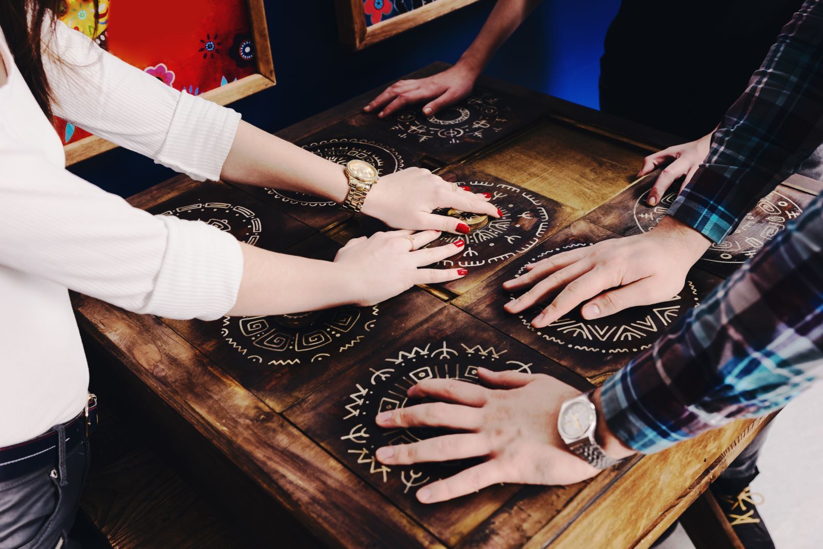 Three pairs of hands solve puzzles.